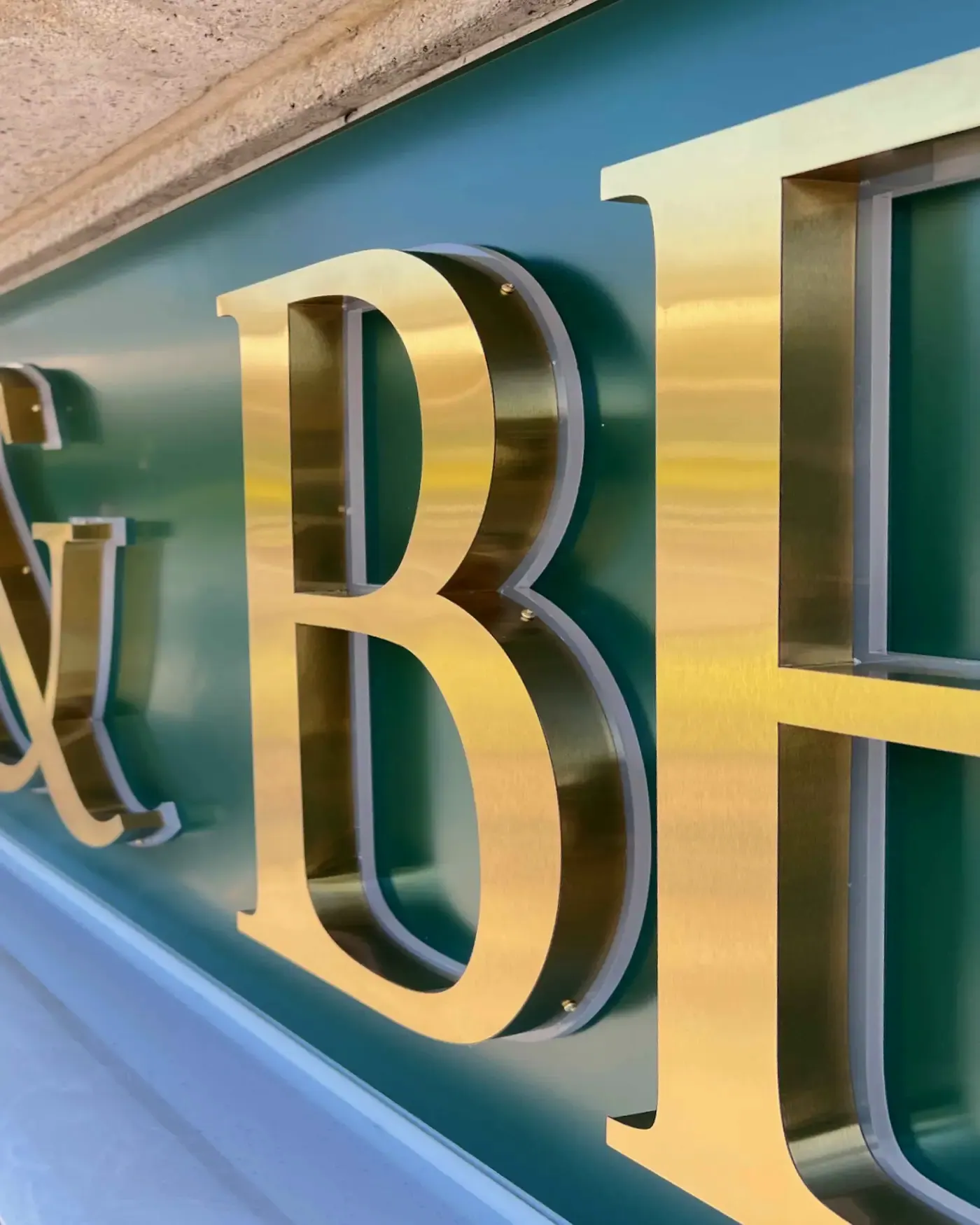 Close-up of brushed gold built-up letters at Blends & Beyond