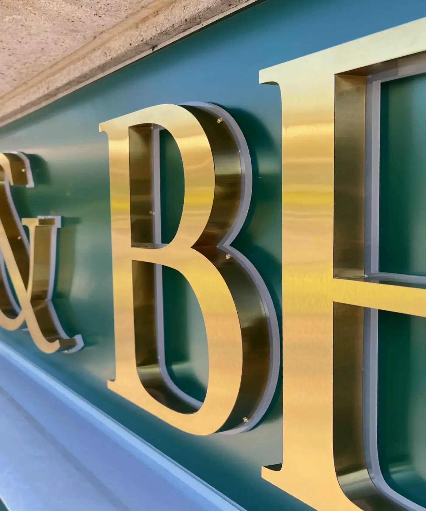 Brushed gold built-up letters fabricated by Sign Group