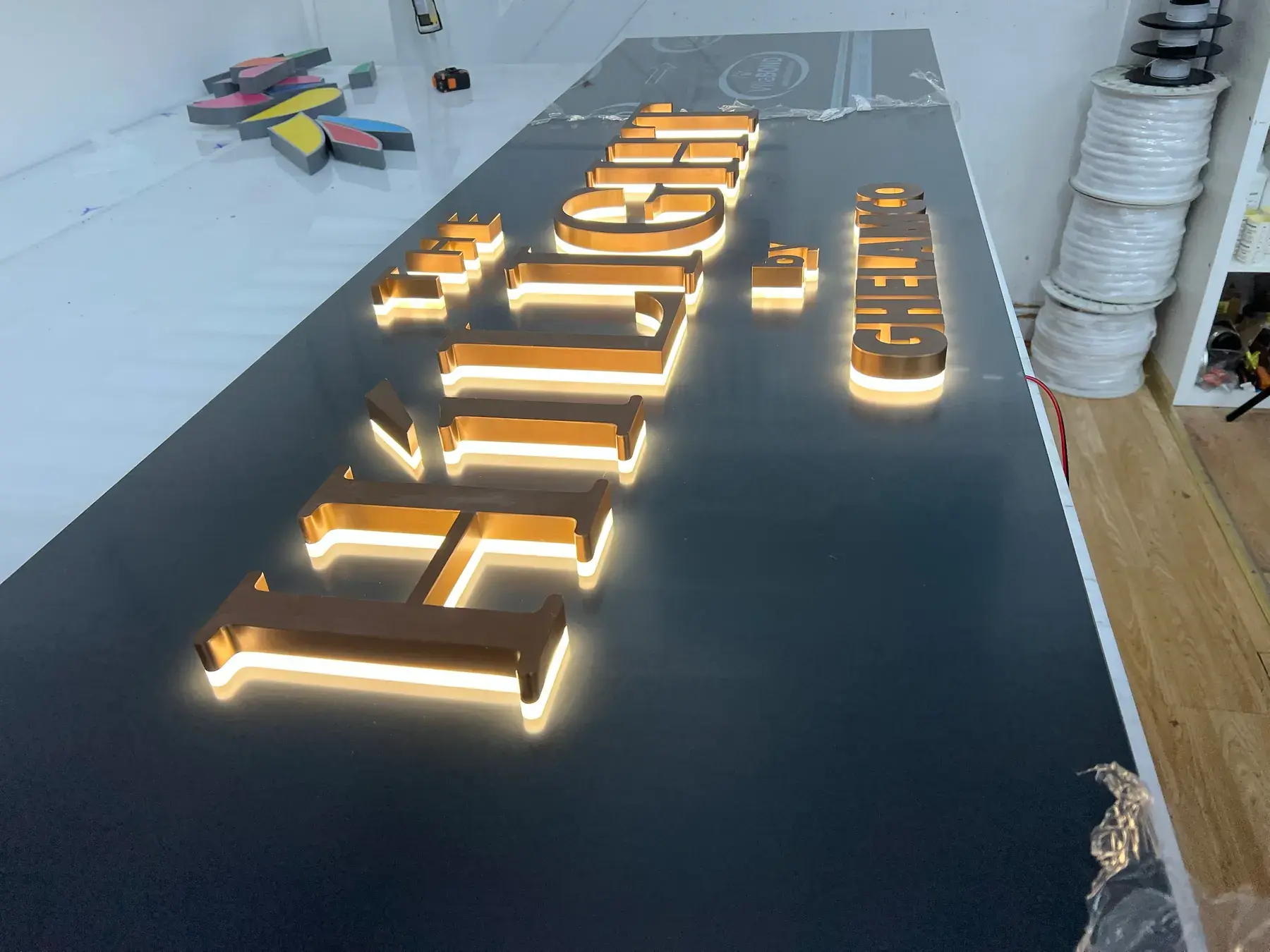 The Hilight by Ghelamco letters seen along their length, each one halo-lit