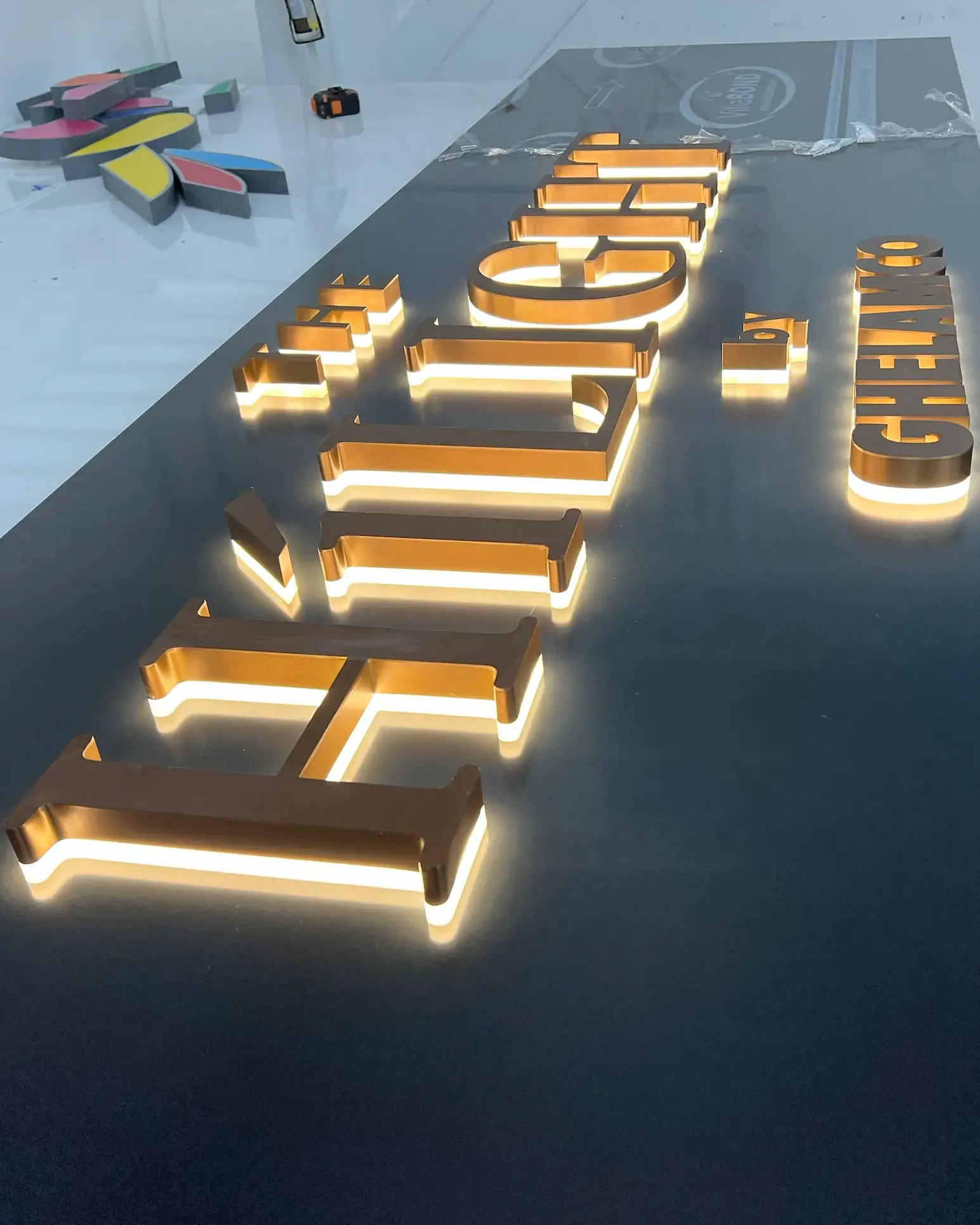 The Hilight by Ghelamco: brushed rose gold stainless steel letters seen along their length, each one halo-lit